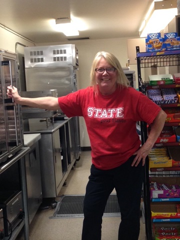 Carmella Smith hands out pizza and blueberry muffins with a smile every day in the lounge.