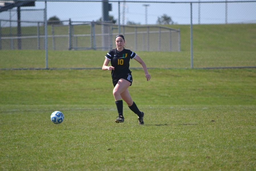 During the Intercity soccer game vs. Normal Community senior Elena Hollingsworth moves the ball up the field.