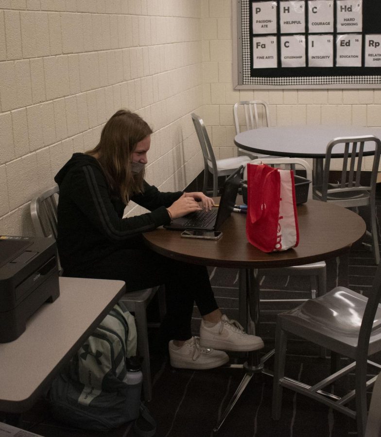 Even in the absence of her peers, junior Lynnae Wollenweber sits in the U-Link and works on her homework all while following the mask policy.