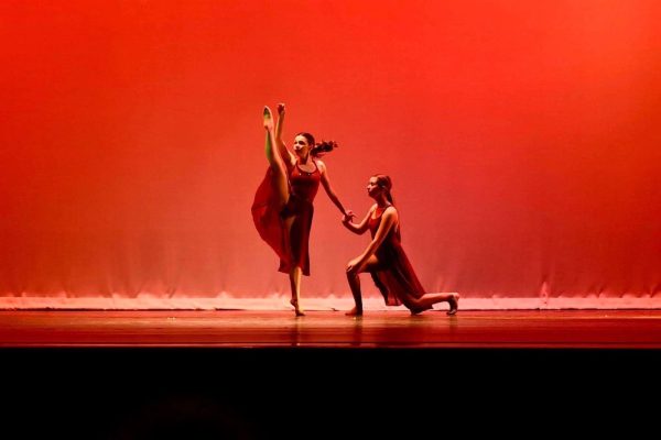 In the last Orchesis recital held in Stroud Auditorium in Spring of 22, Sarah Jacobs performs a battement in her recital with sophomore Gabbi Walker. 