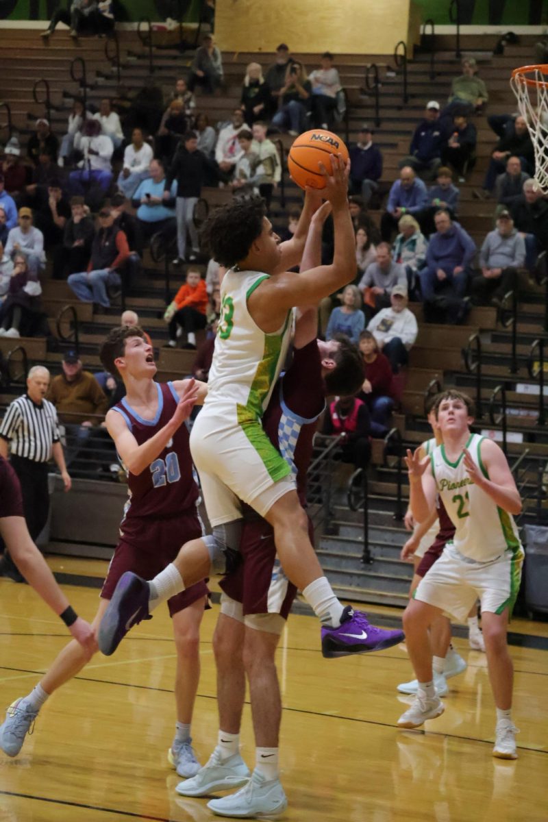 Breaking through! Senior Cameron Johnson goes for a layup against St. Joseph-Ogden on December 27, 2025. The Pioneers won 58-50. 